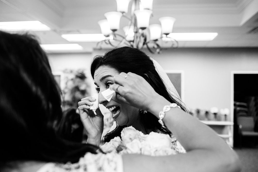 Bride wipes away tears after wedding ceremony