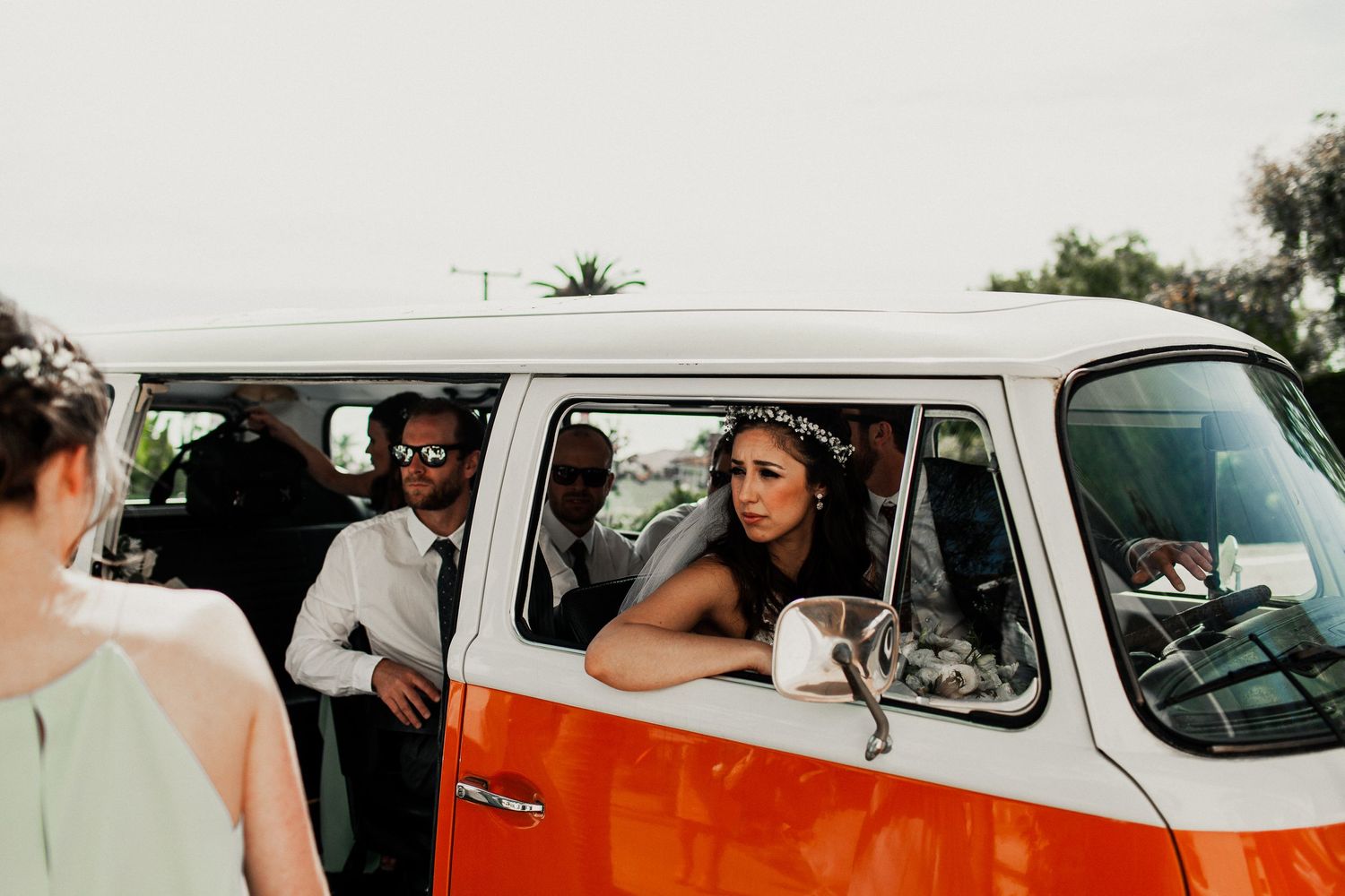 bride looking outside window of volkswagon van