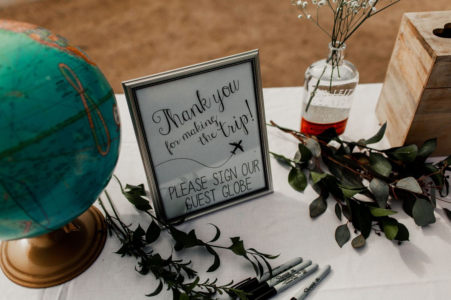 reception decor and sign in with globe at wedding reception