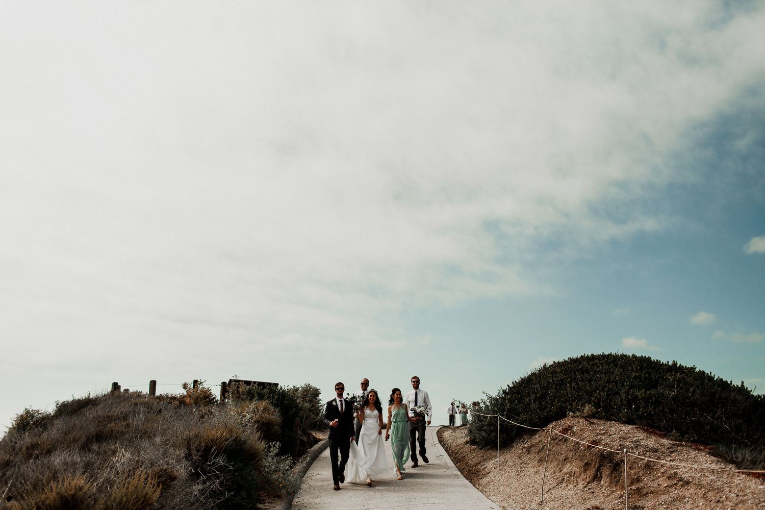 bridal party walking down to crystal cove beach