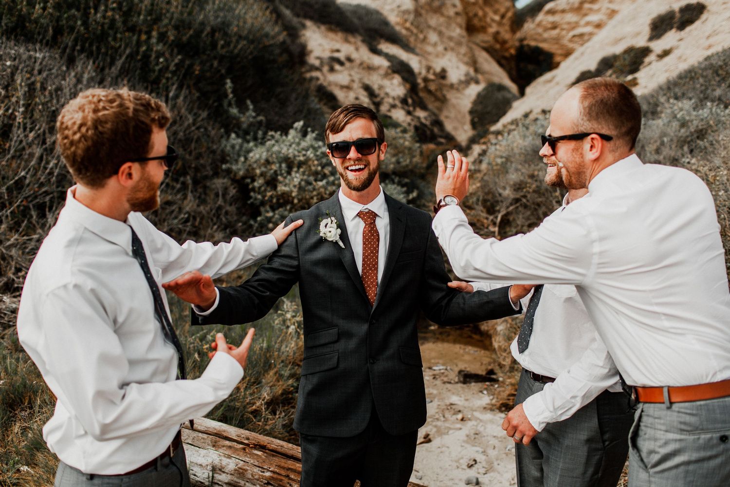 groomsmen congratulating each other at crystal cove