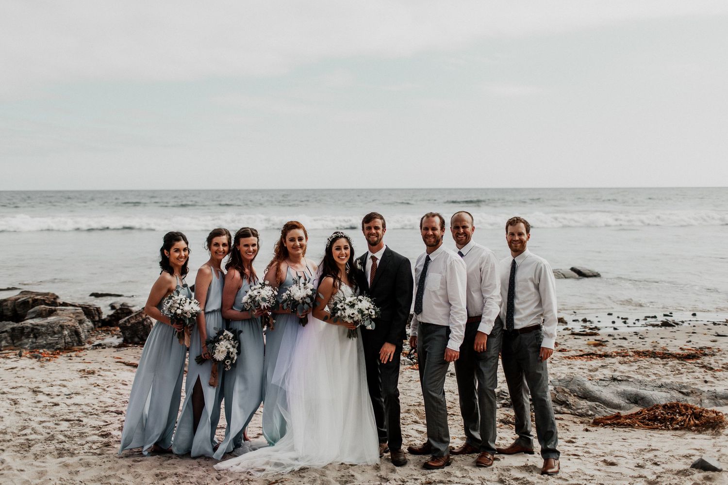 entire bridal party with crystal cove beach background