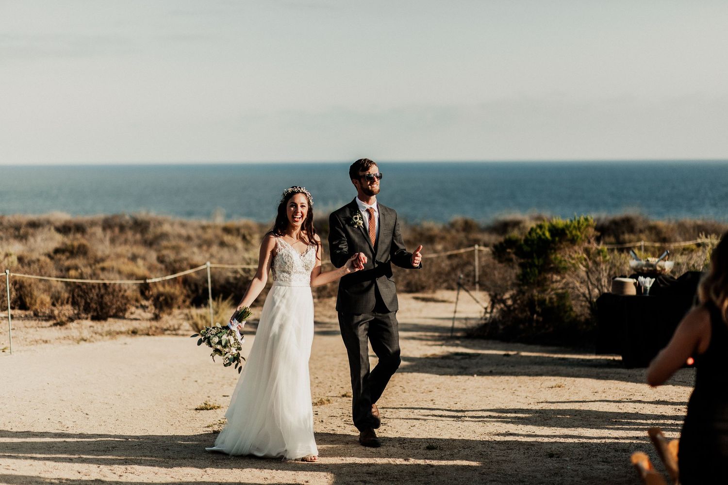 bride and groom walking to their reception at crystal cove