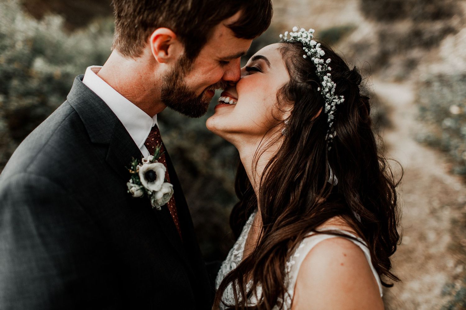kissing each other bride and groom