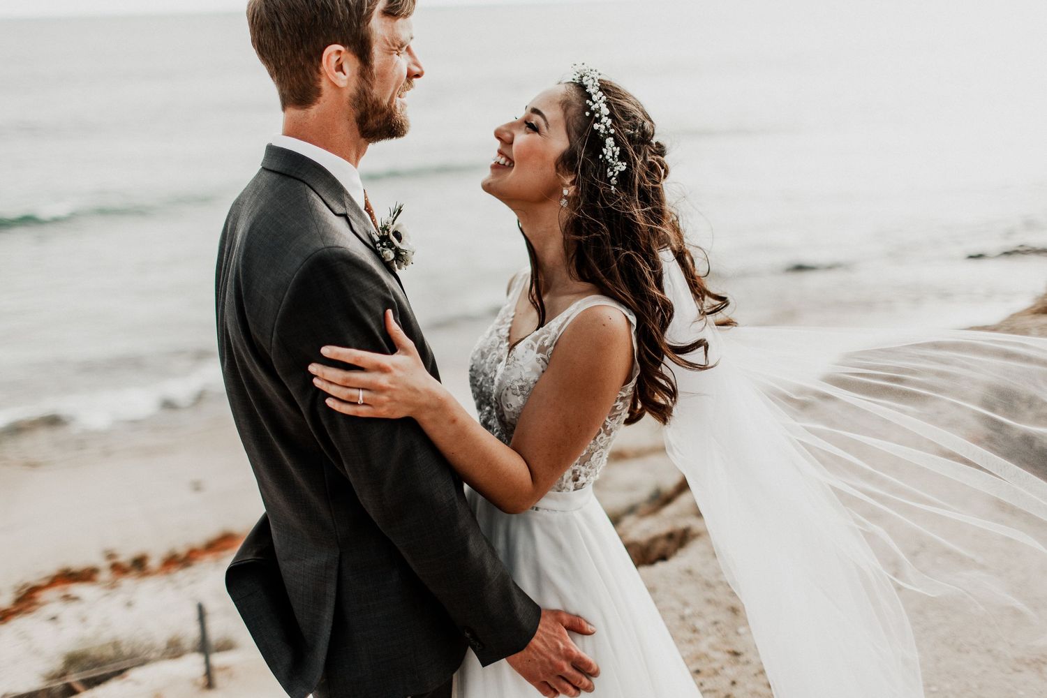 portraits of bride and groom looking at each other