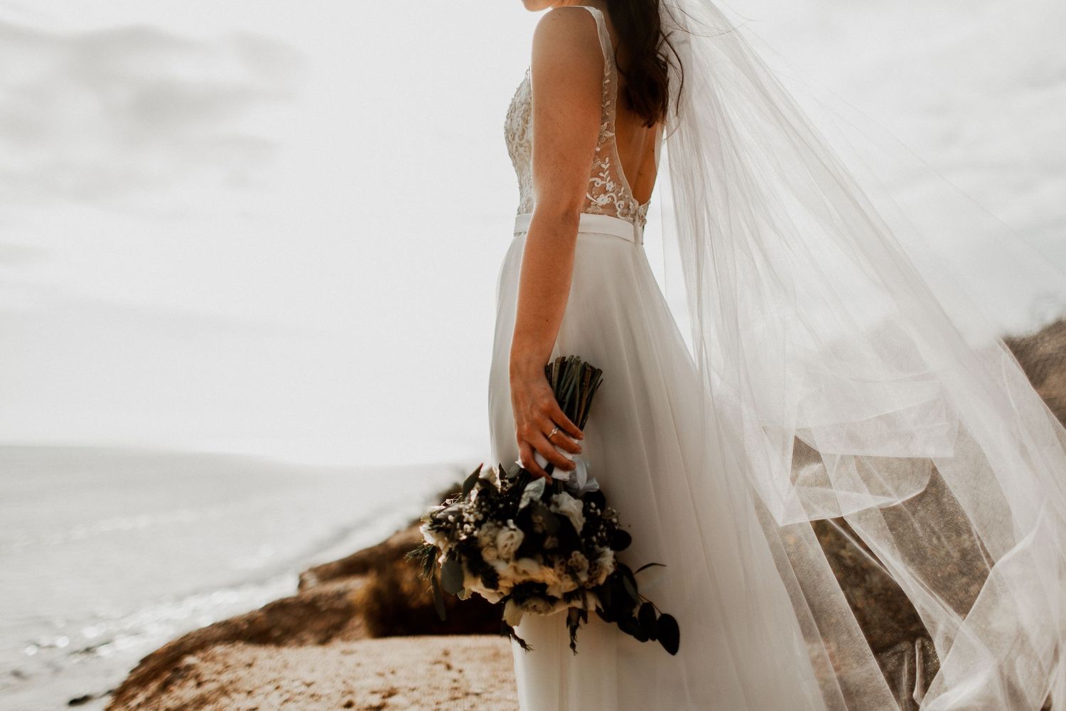 bride solo picture with bouquet flowing with the wind