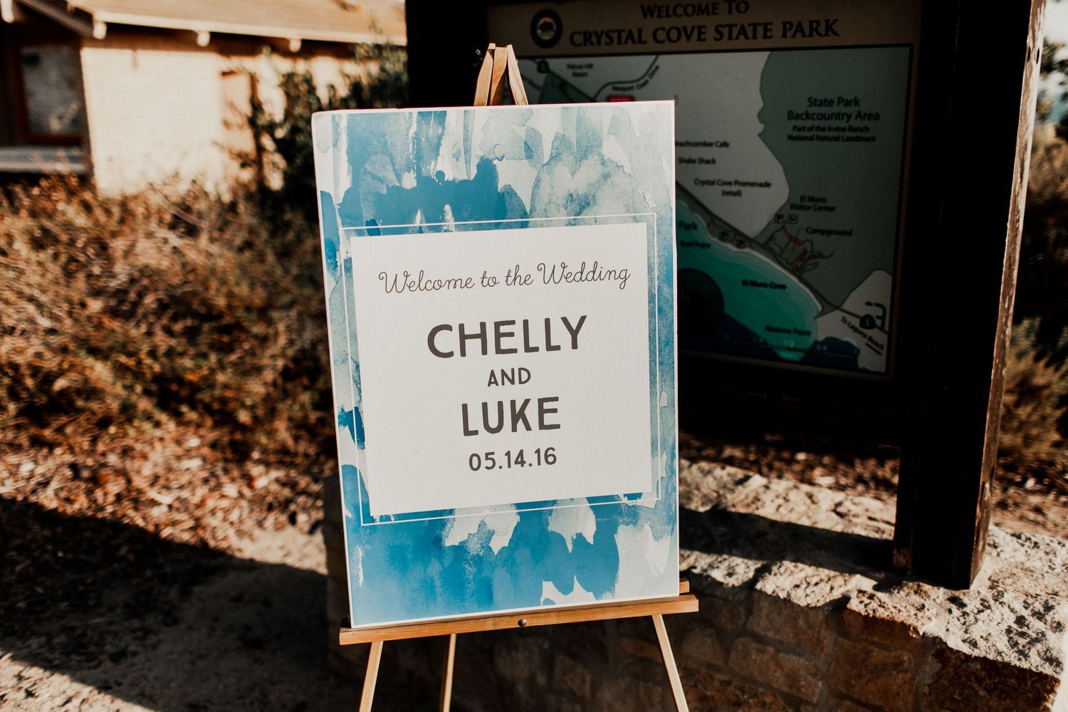 entrance sign at crystal cove wedding