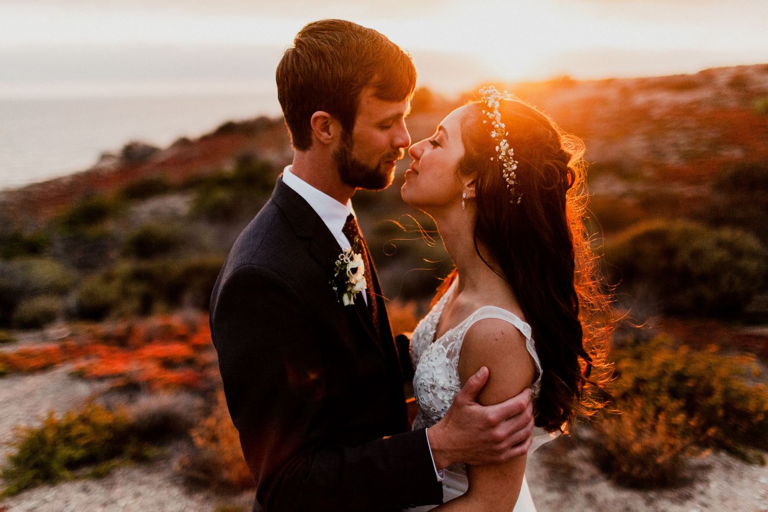 sun back light golden hour with bride and groom about to kiss