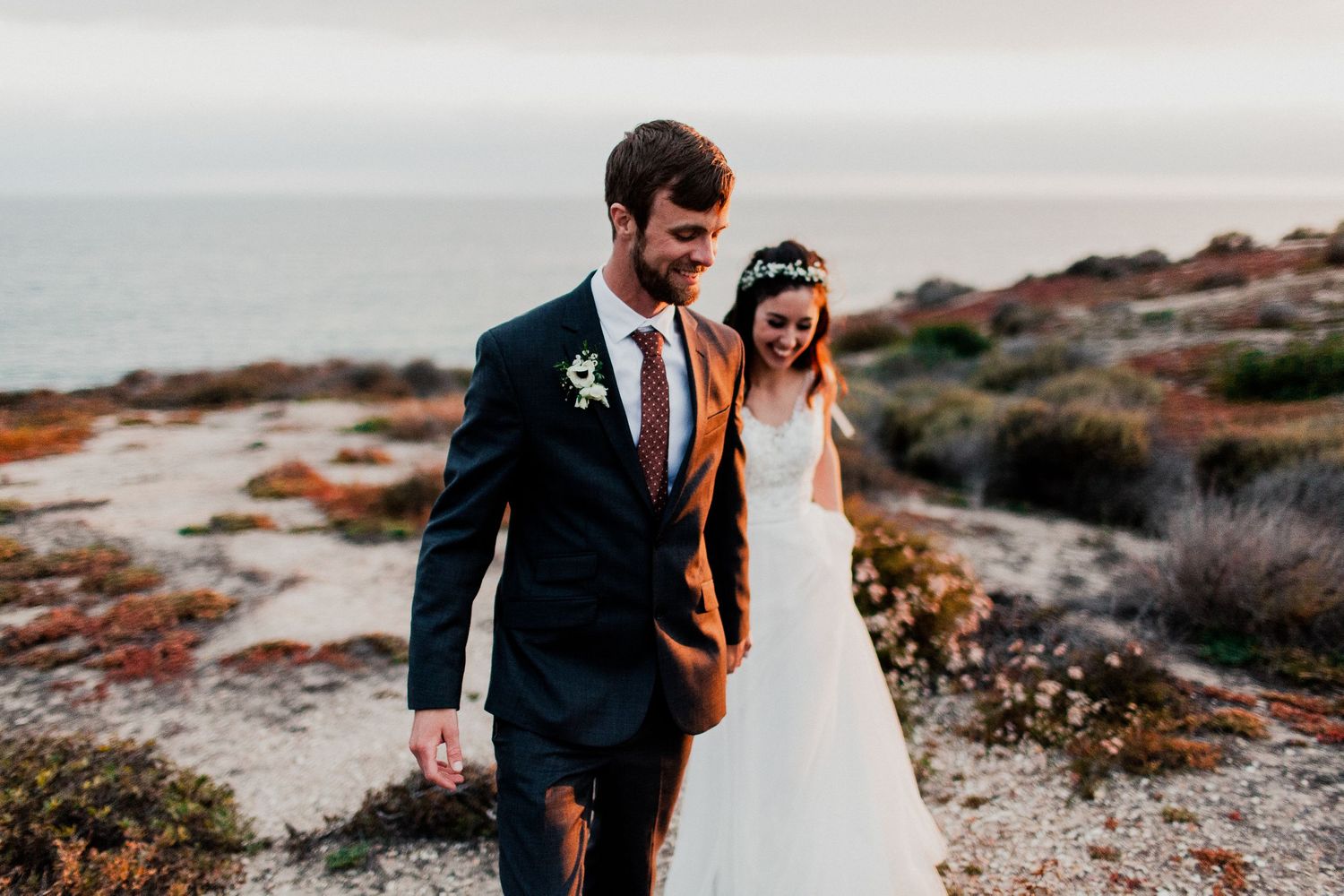 bride and groom walking at beach