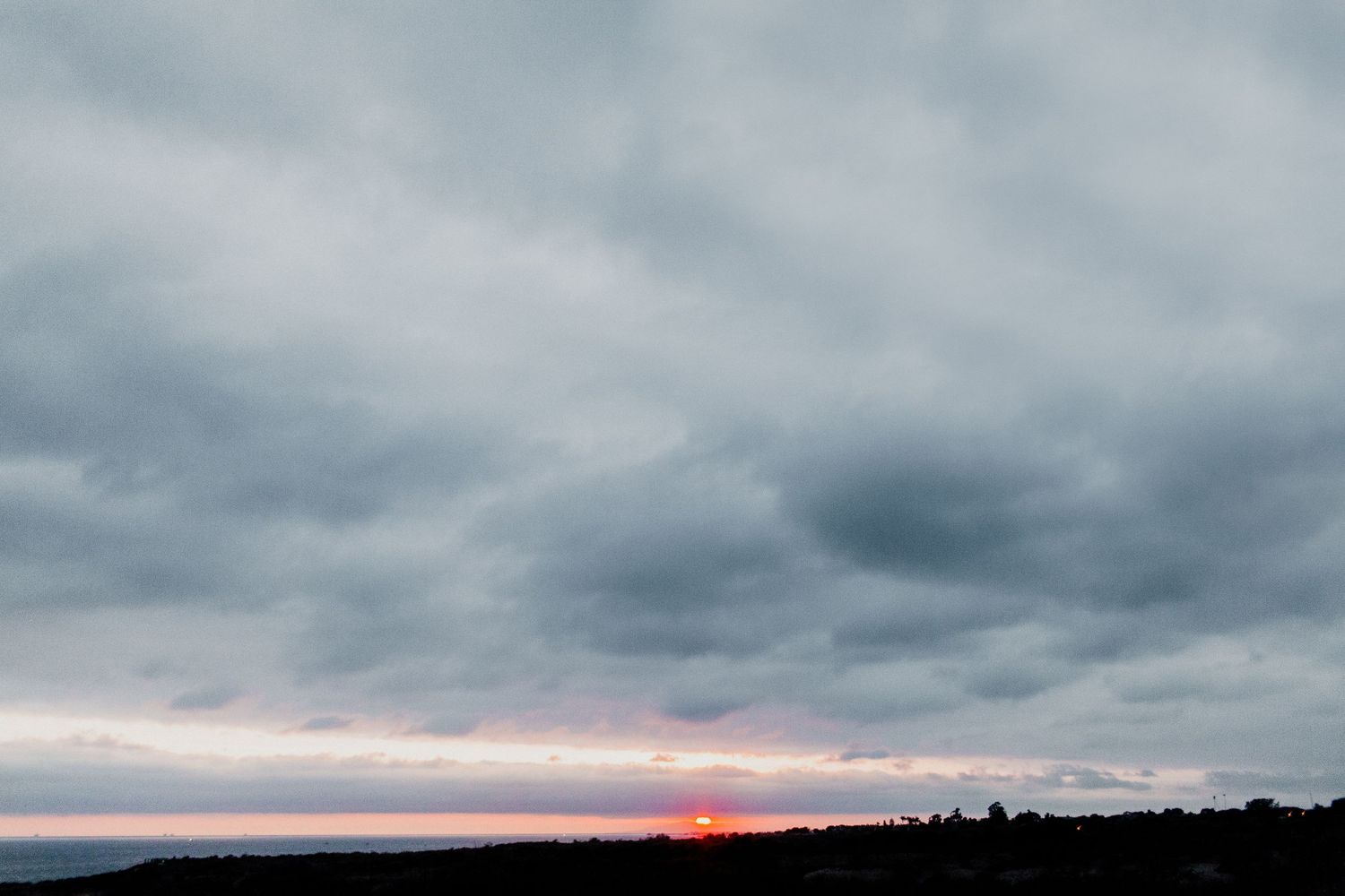 moody and cloudy sunset at the beach