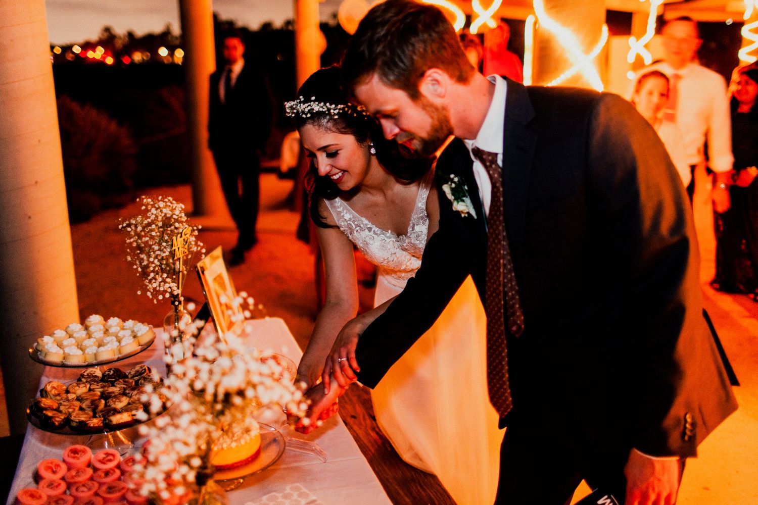 bride and groom cut cake after dancing