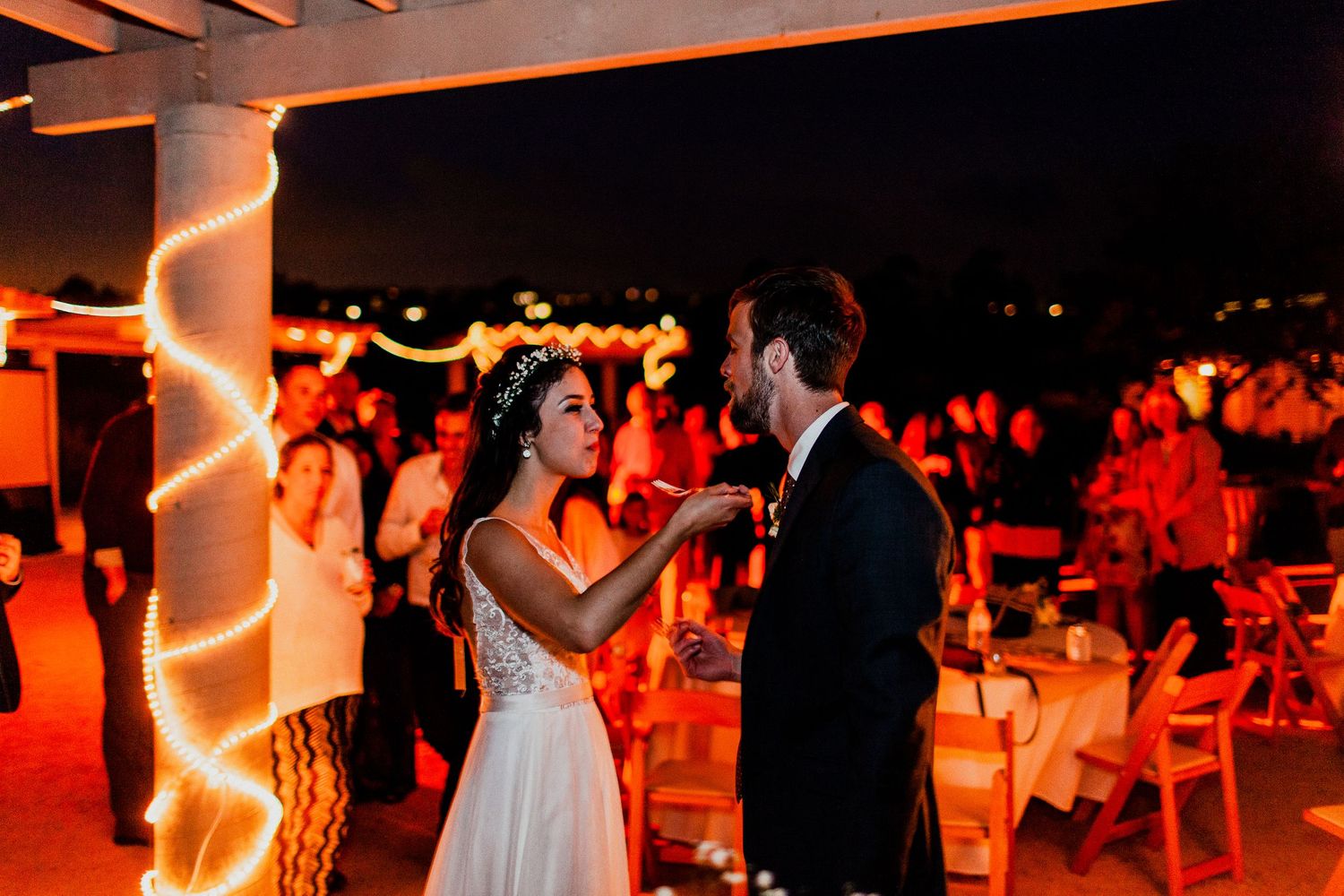 bride and groom feeding cake to each other