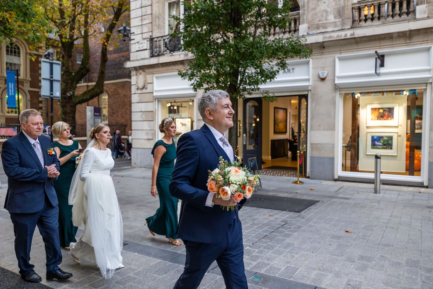 wedding party walking through Liverpool City Centre to the Athenaeum wedding venue. Stuart Morris Photography
