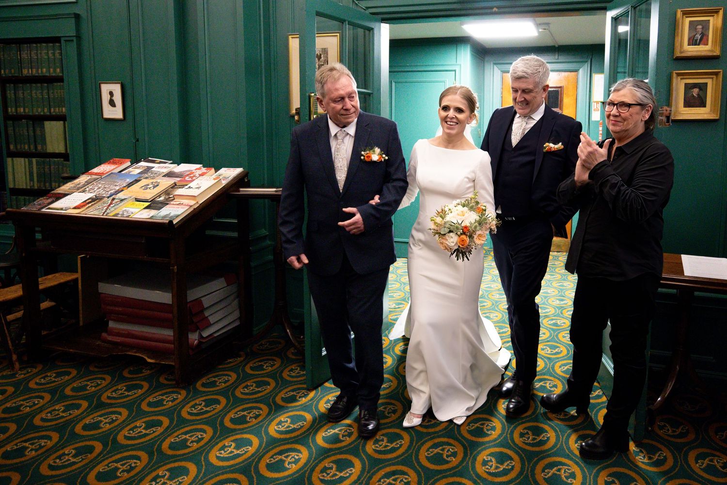 bride groom and father of the bride enter the library at the Athenaeum Liverpool City Centre wedding reception venue.