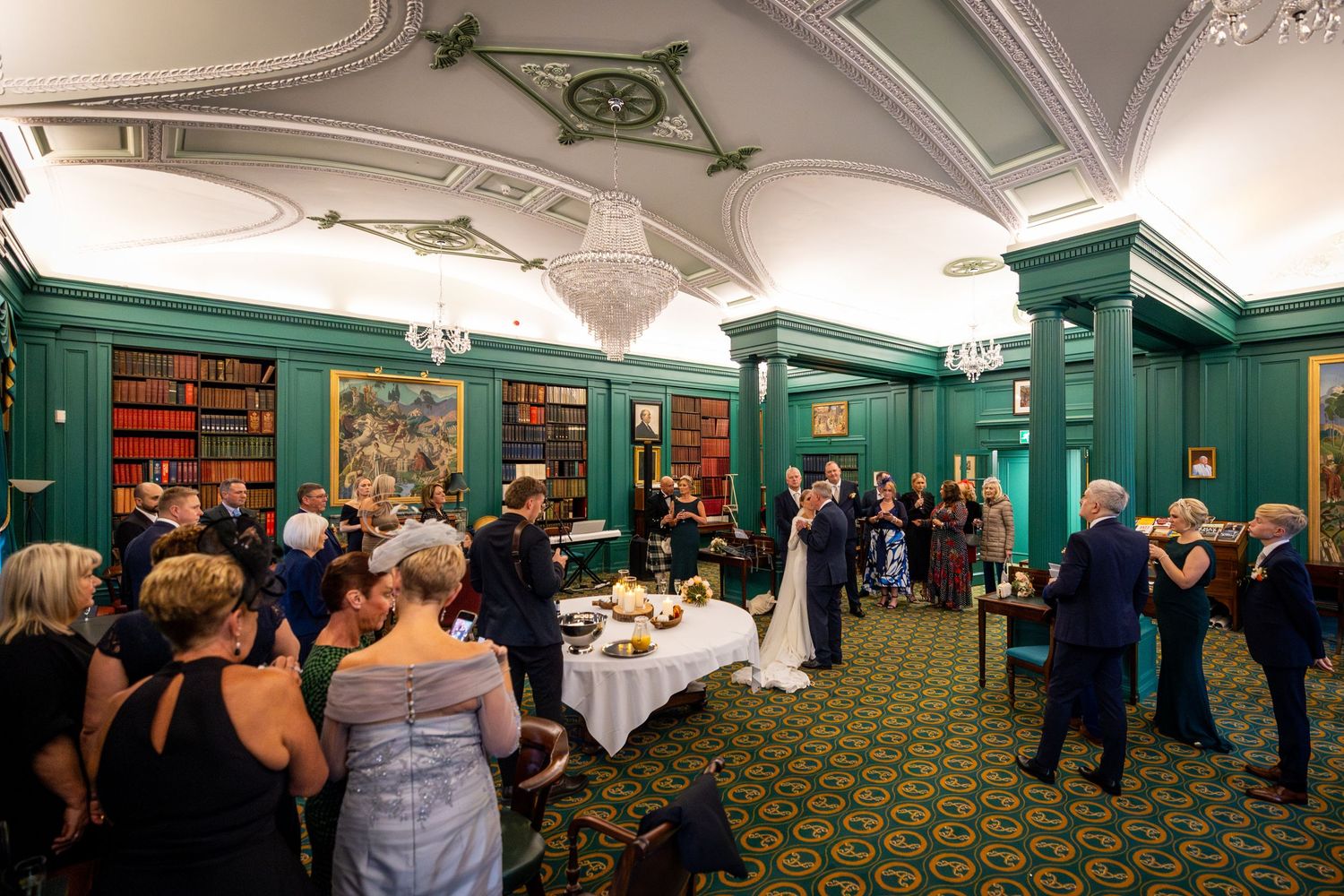 bride and her father share a dance watched by wedding guests in the library at the Athenaeum Liverpool City Centre.