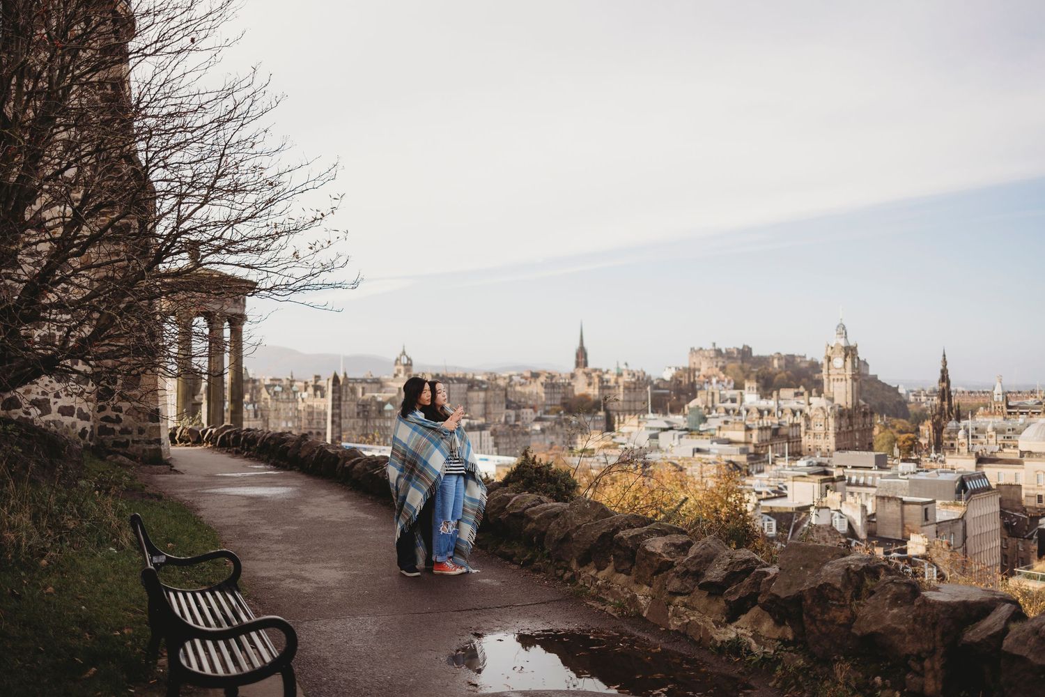 Edinburgh cityscape panorama view of historic buildings and church spires along winding pathway in autumn.