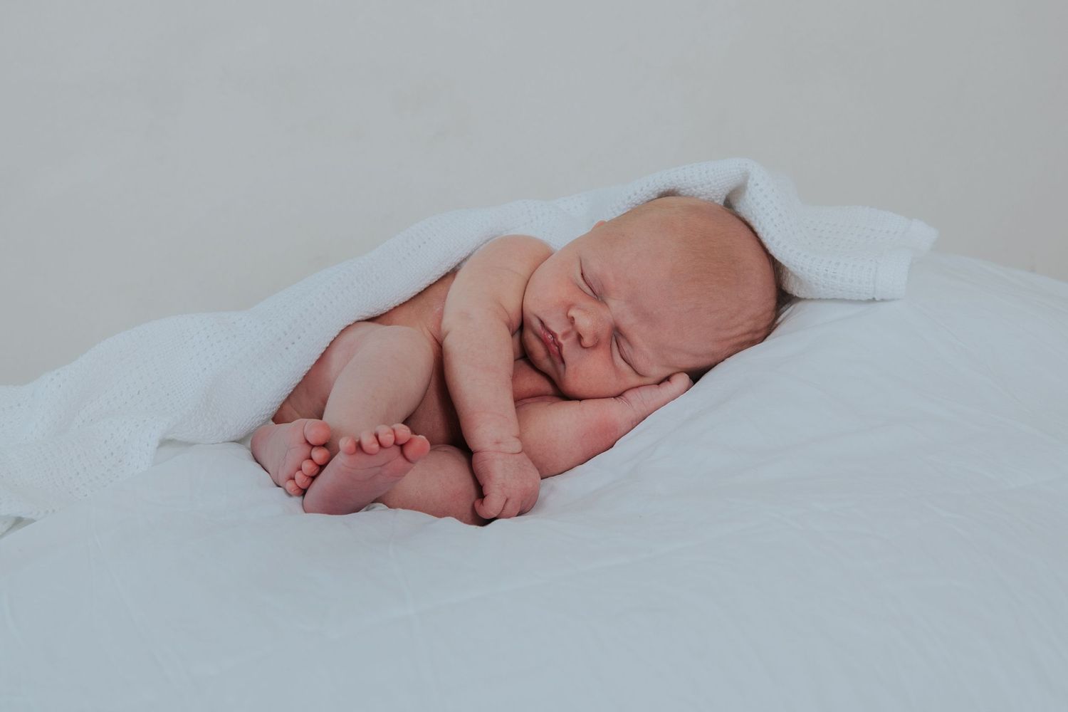 Simple white newborn baby photograph by Devon newborn photographer Melanie Barnfield