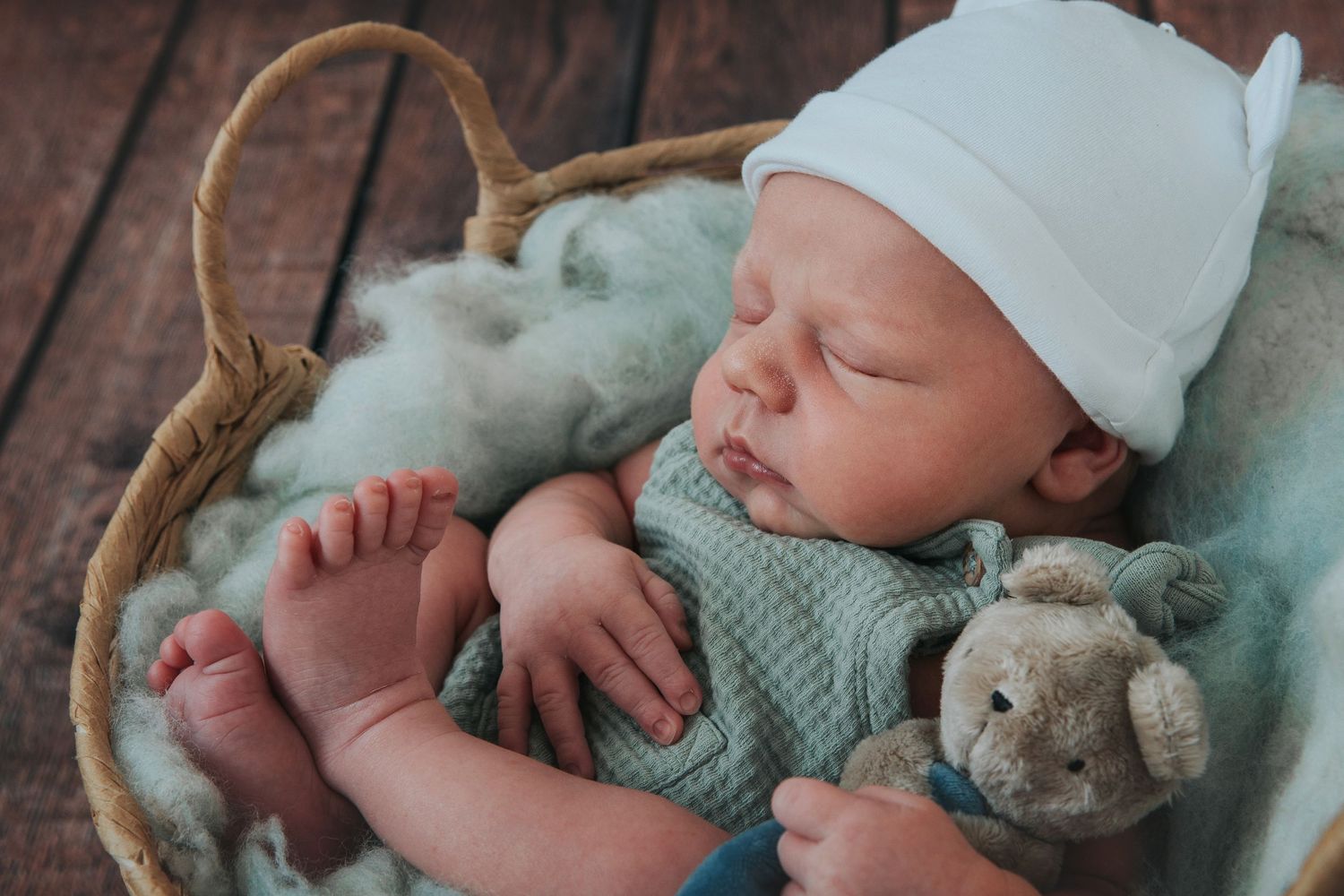 Baby in basket by Melanie Barnfield Photography
