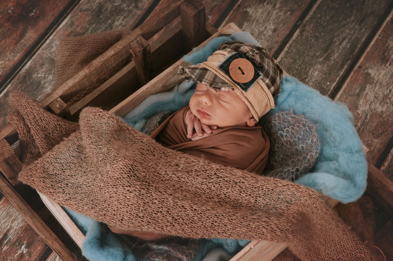 Cute newborn baby in box by Devon newborn photographer Melanie Barnfield