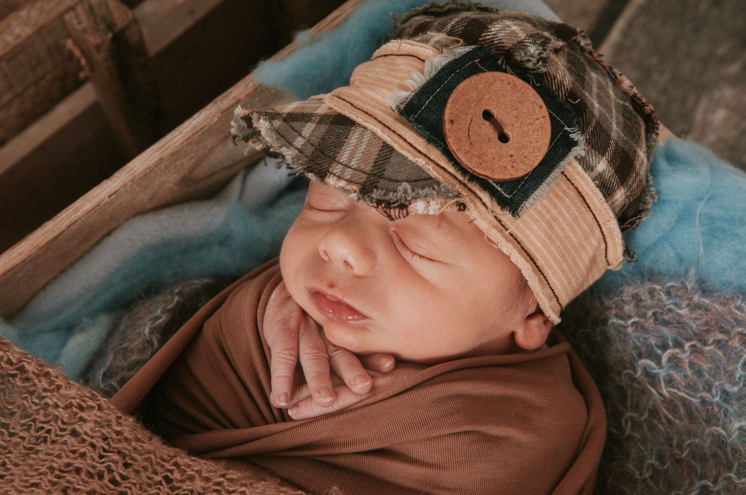 Cute newborn baby in box by Devon newborn photographer Melanie Barnfield