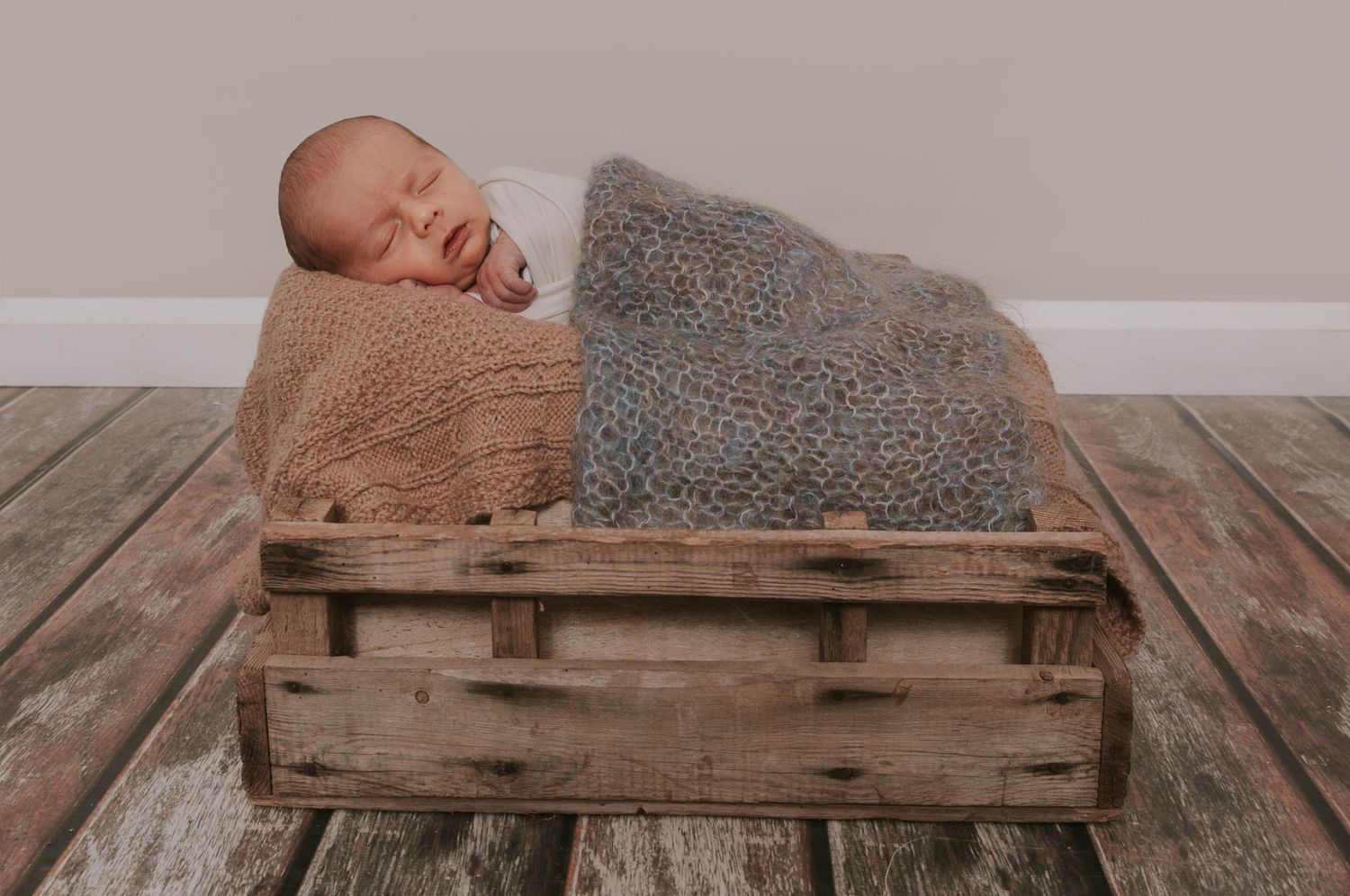Baby boy on box by Devon newborn photographer Melanie Barnfield