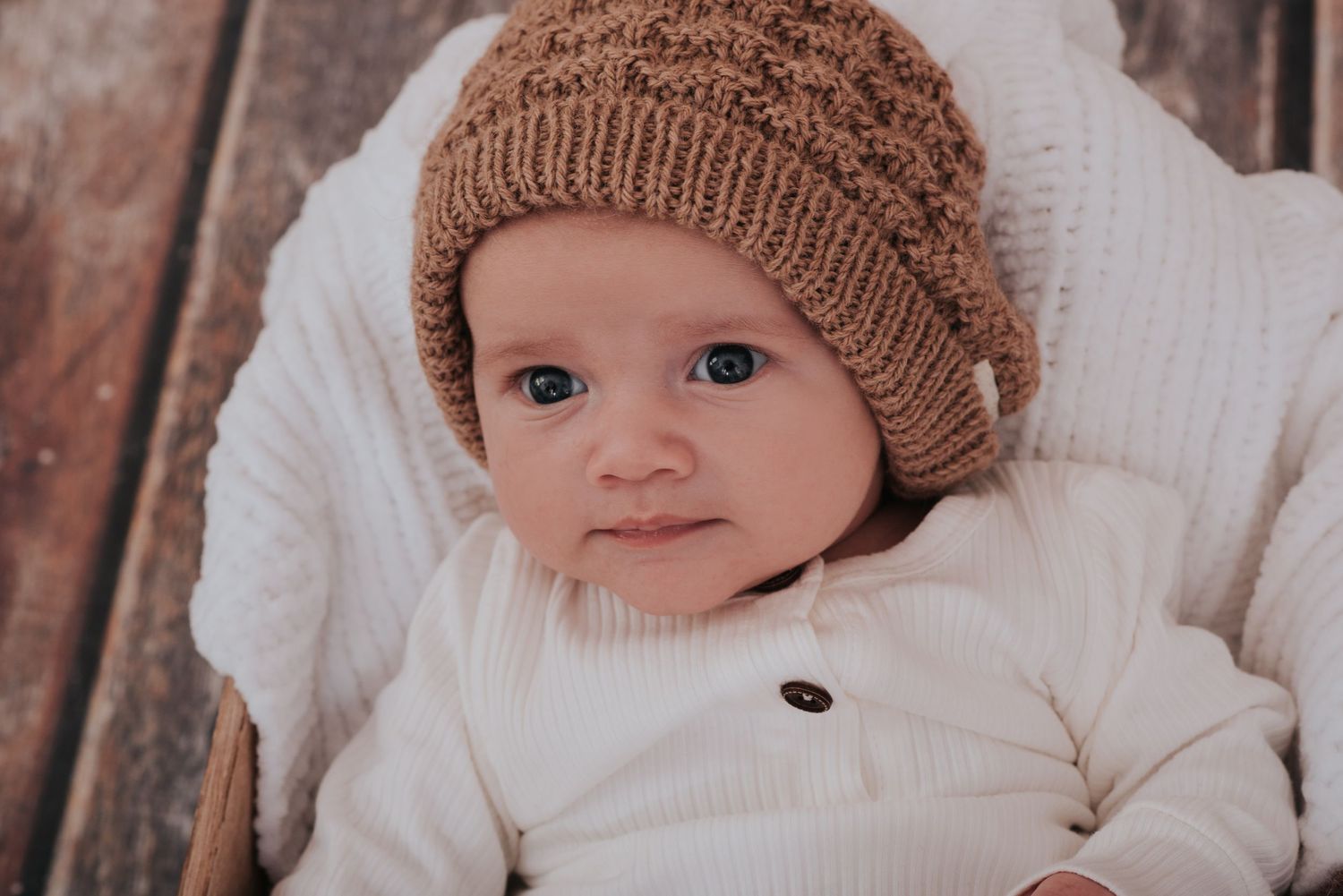 Cute newborn baby with woolly hat by devon photographer Melanie Barnfield