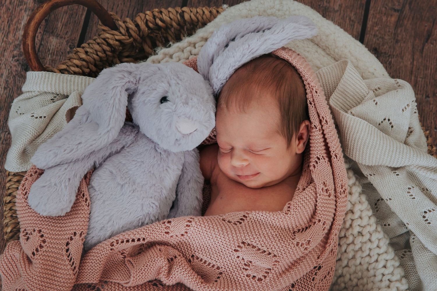 Newborn baby and toy bunny snuggling together by devon photographer Melanie Barnfield