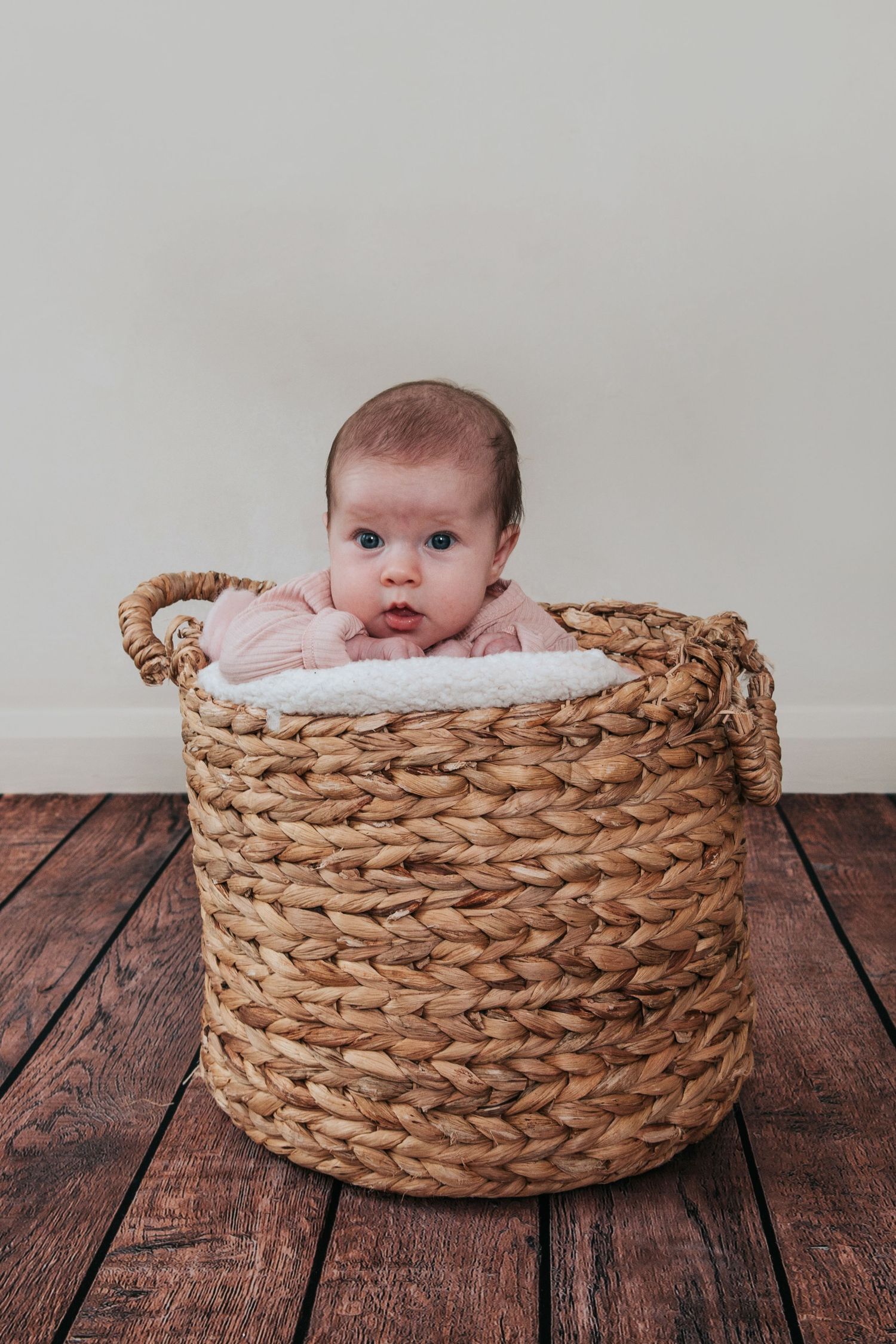 Cute baby in a basket by Melanie Barnfield Photography