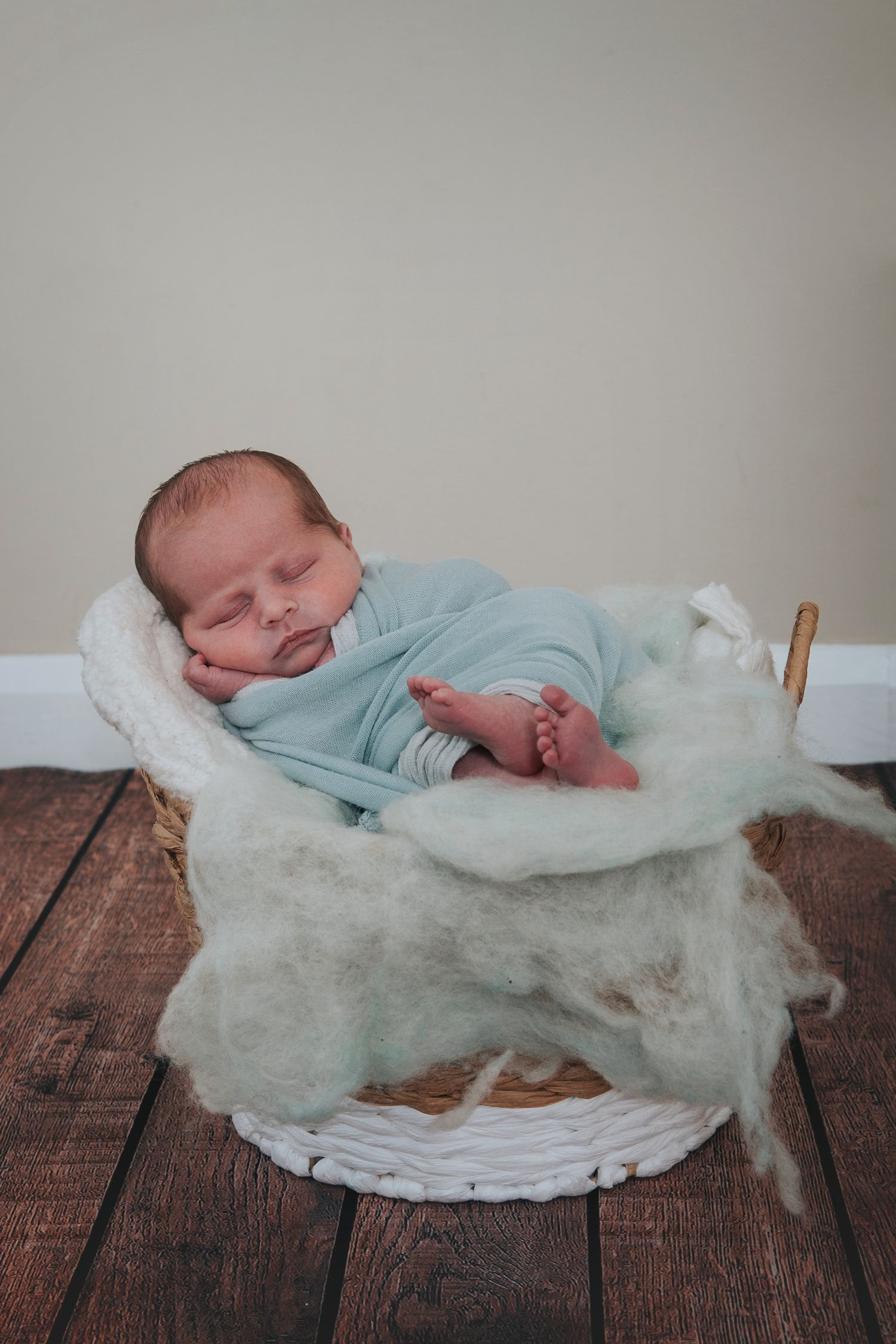 Baby boy in a basket by Melanie Barnfield Photography