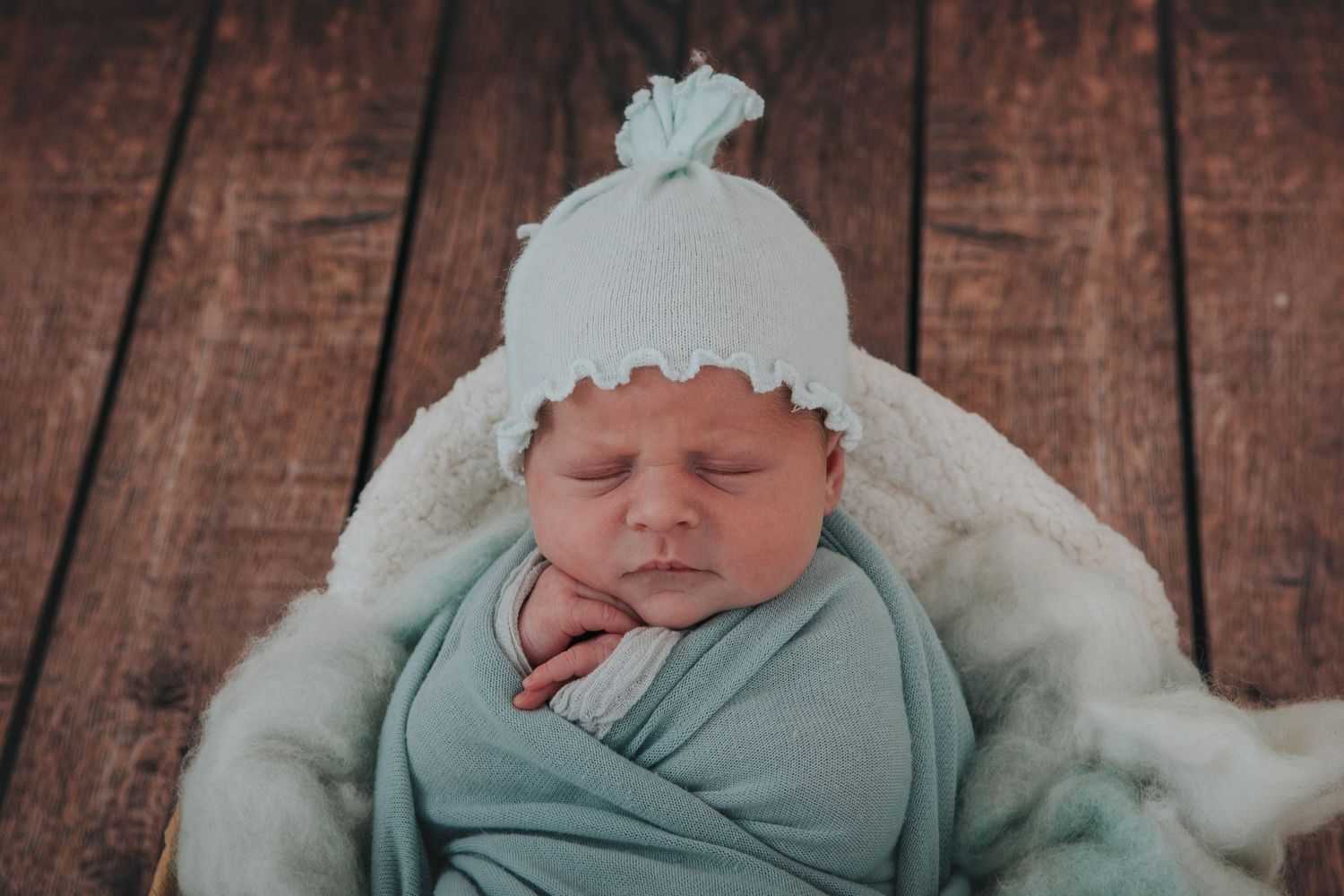 Baby in beautiful hat by Melanie Barnfield Photography