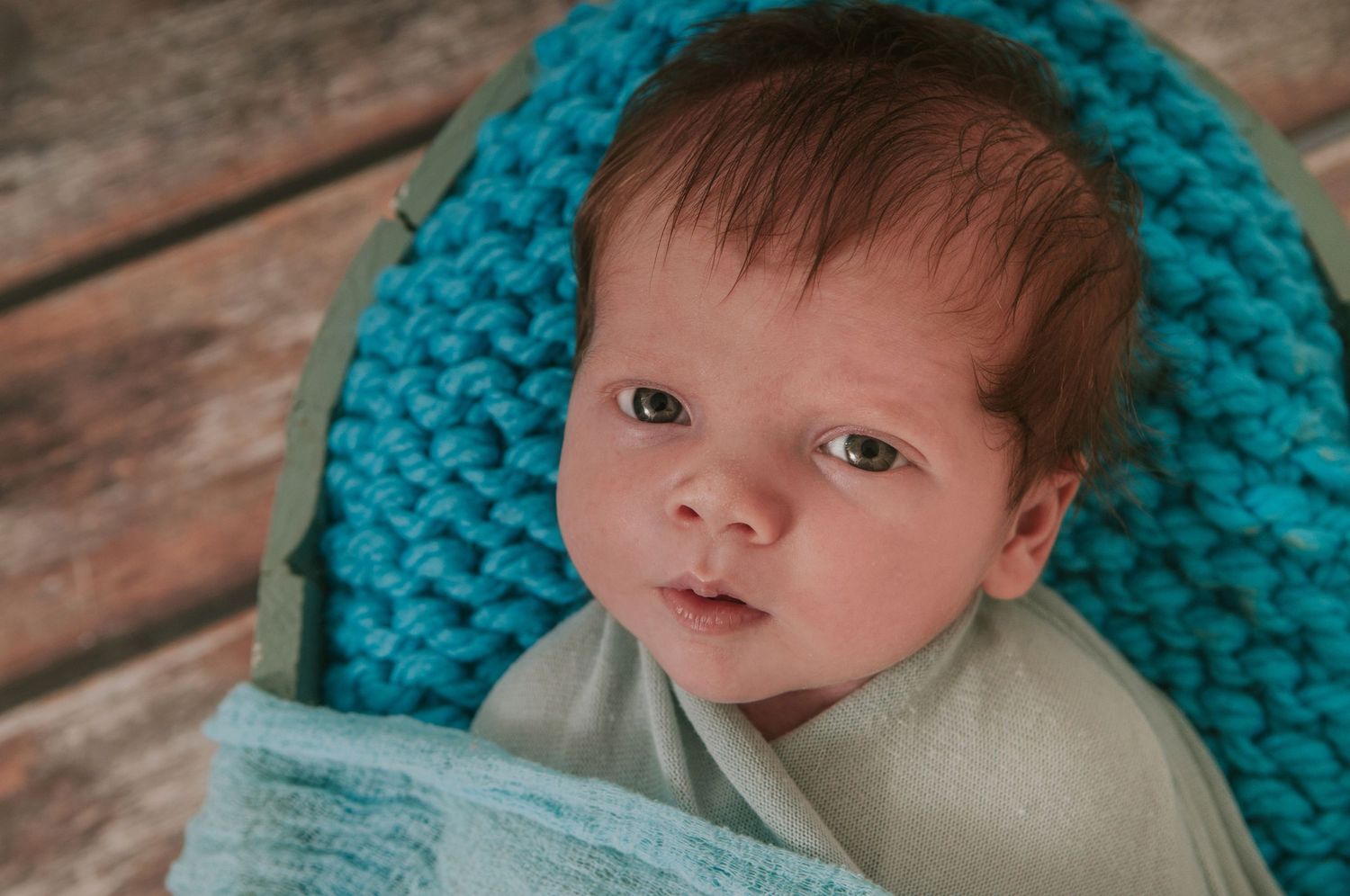 Beautiful baby boy looking into camera by devon based photographer Melanie Barnfield