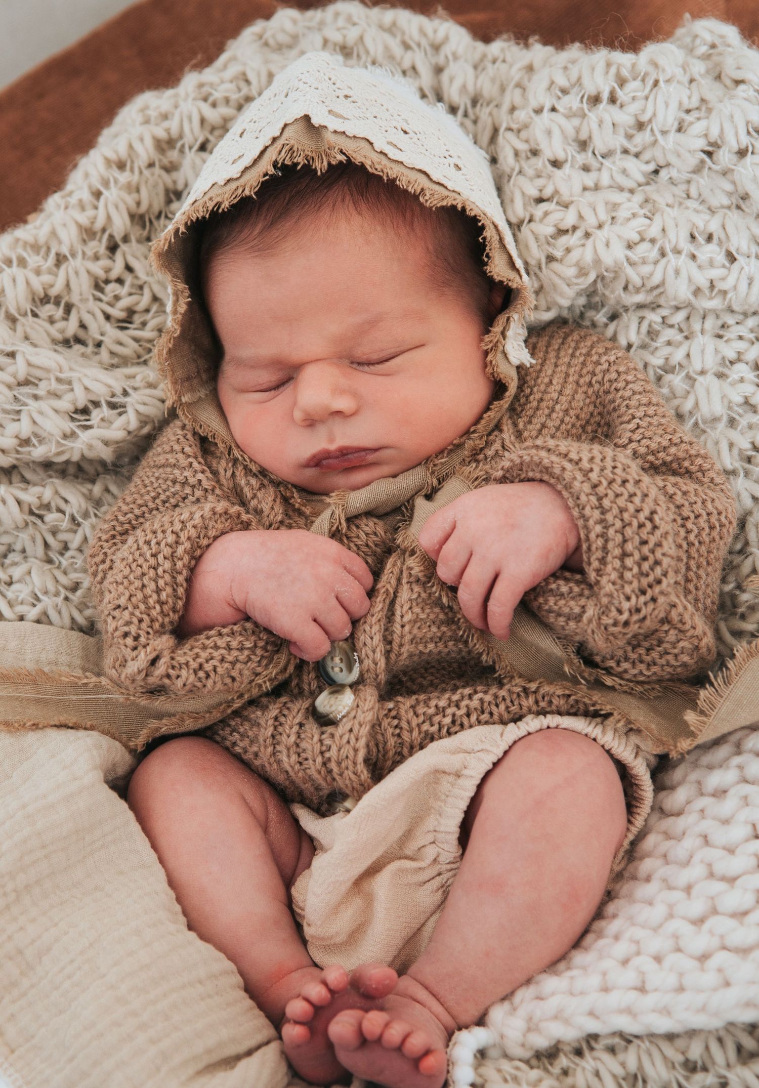 Baby girl in boho hat and cardigan by devon based photographer Melanie Barnfield