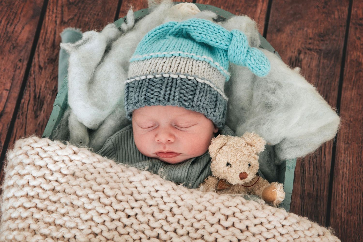 Sleeping baby with cute woolly hat and teddy by devon based newborn photographer Melanie Barnfield