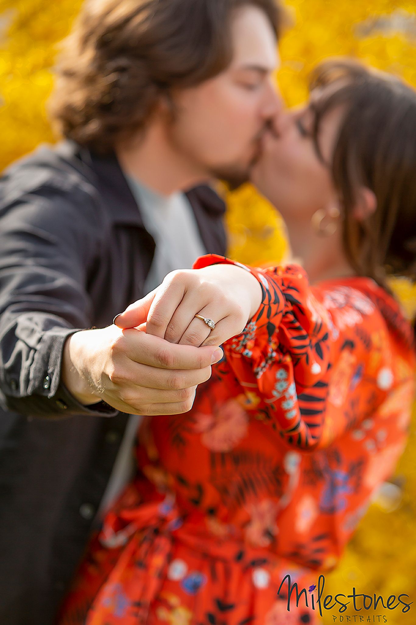 engaged couple kissing
