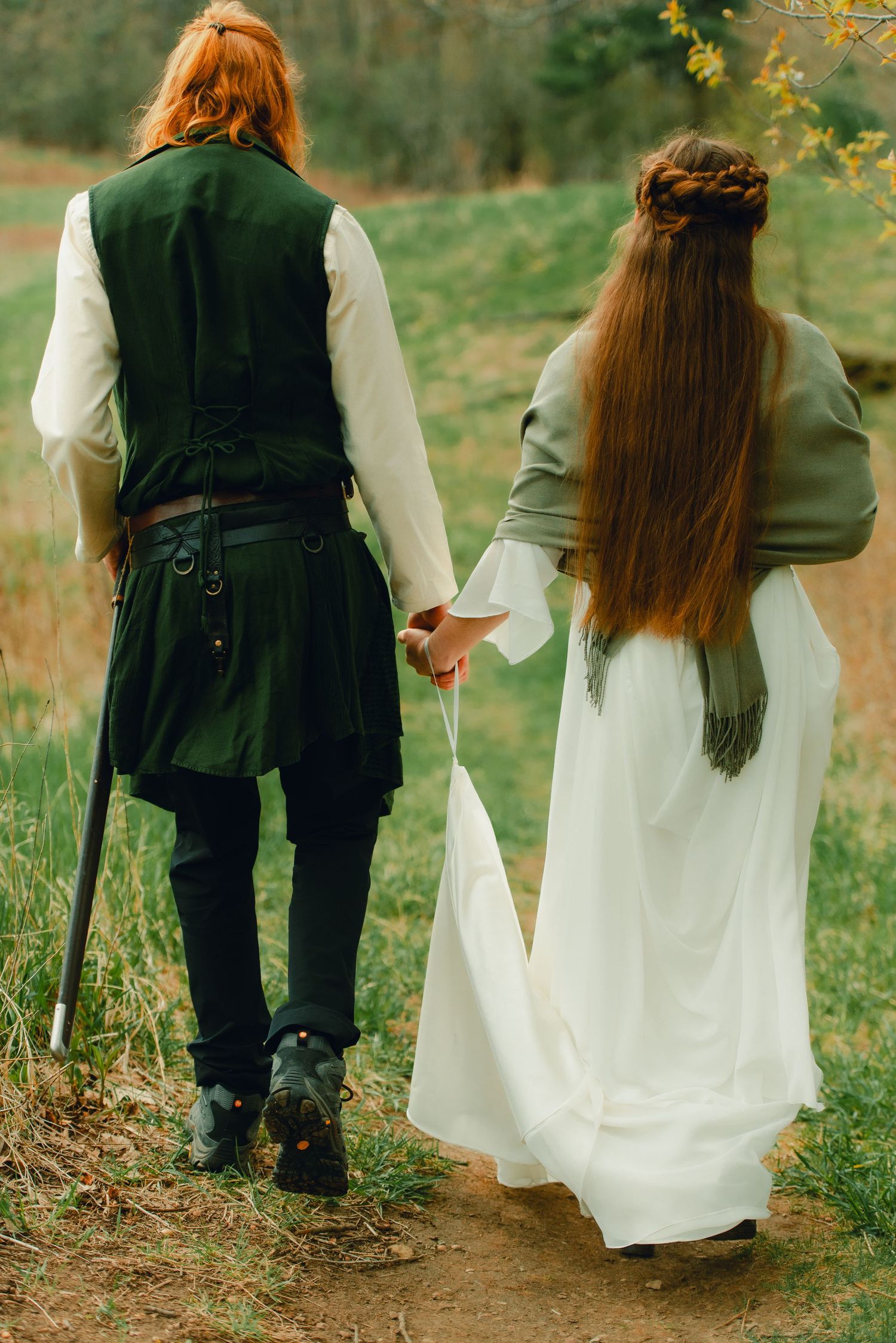 Couple walking into spring forest together.