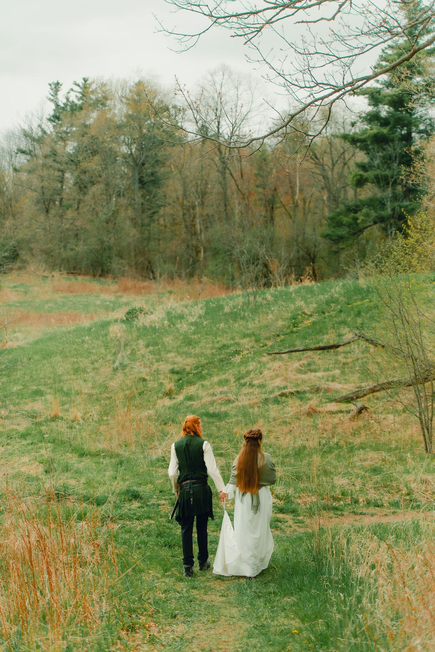 Couple walking into spring forest together.