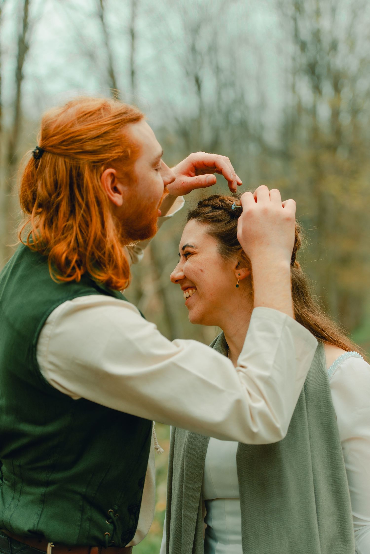 Groom putting flowers in bride's hair