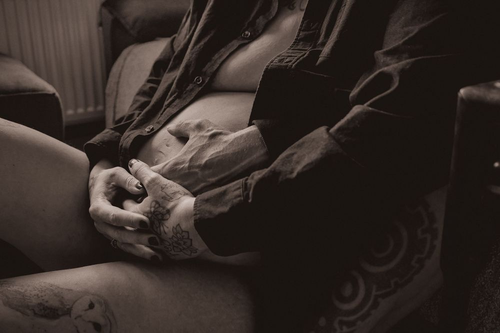 A tender moment with Lizzie and her husband awaiting baby Fenn during her at-home maternity session in Capel St Mary