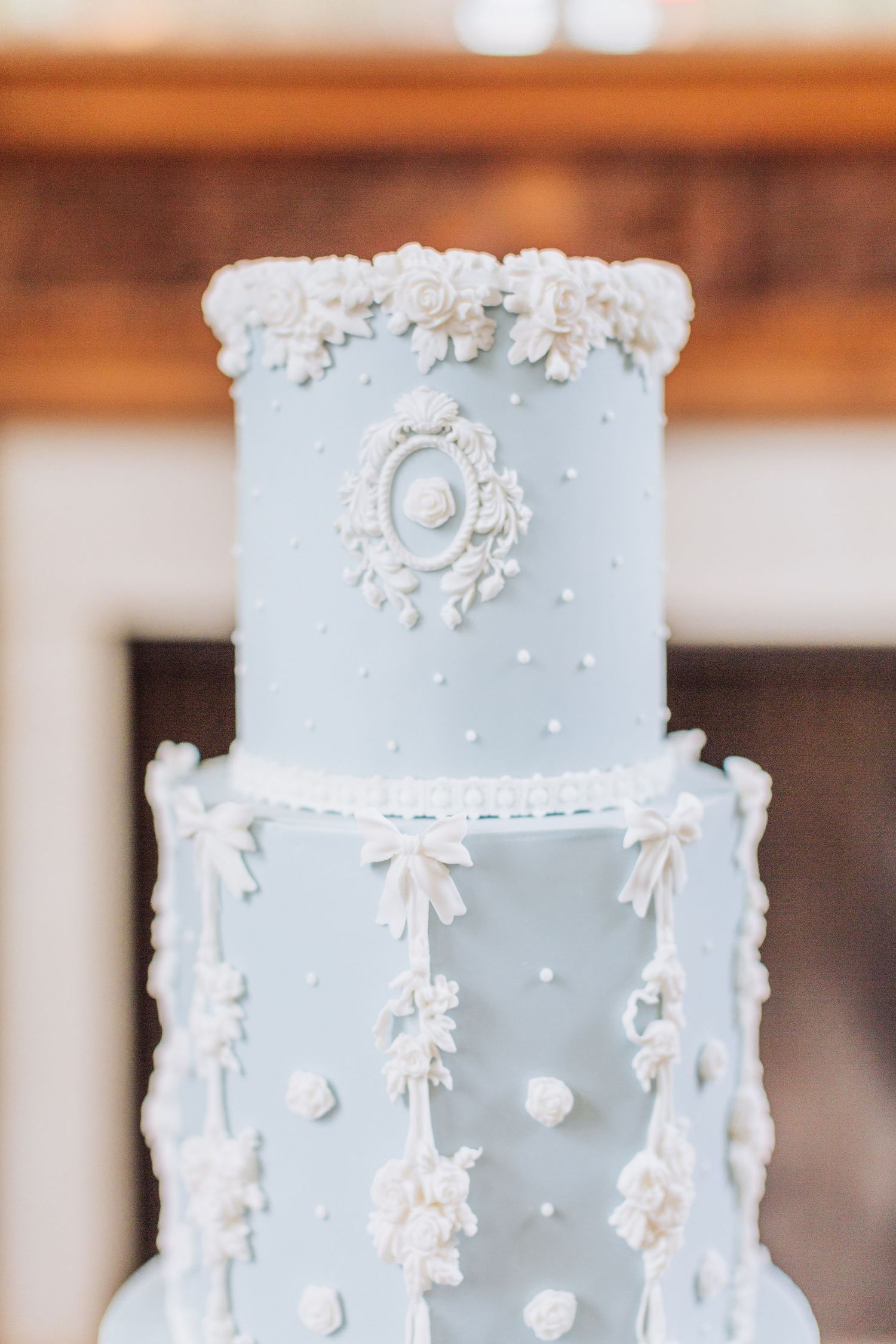 Elegant light blue wedding cake with delicate white piping details and floral decorations at Cornwell Manor by Hayley Elizabeth Photography