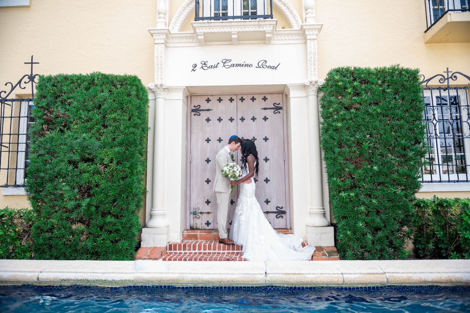 Bride and groom embracing in a garden, beautifully captured by Boca Raton wedding photographers.
