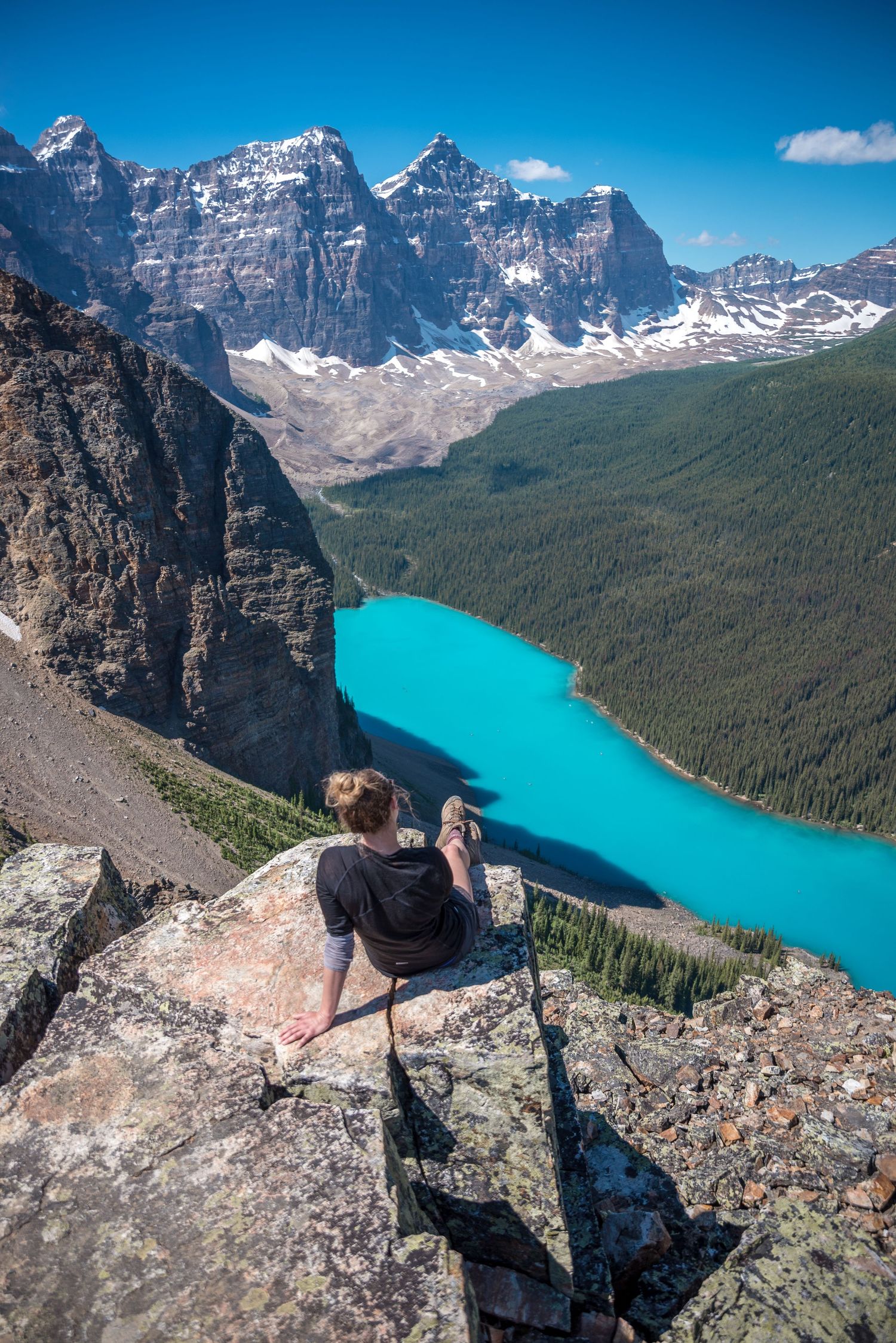 Vibrant turquoise Moraine Lake surrounded by towering mountain peaks in Banff National Park.