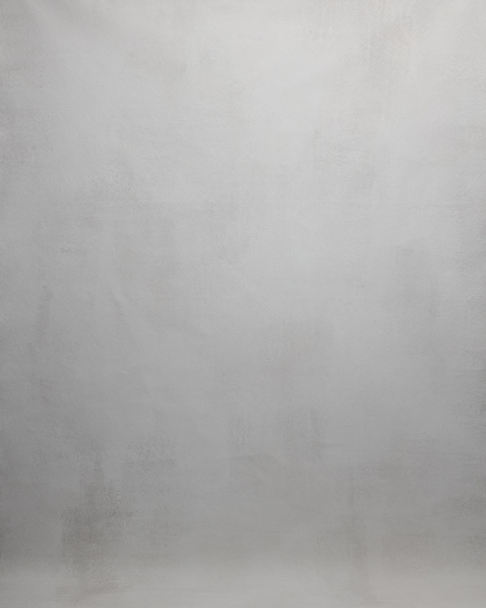 Abstract gray textured background with gradual fading from dark to light tones creating a minimalist atmospheric effect.