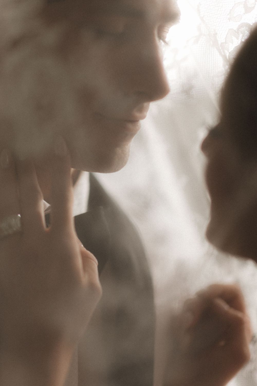 Dreamy soft focus close-up portrait of couple in romantic lighting.