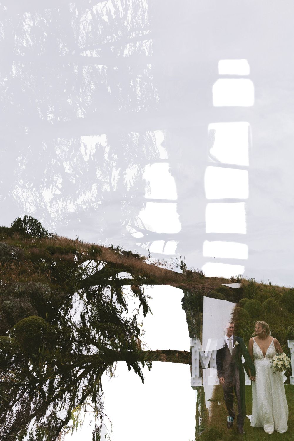 A wedding scene double exposed with trees and sky creating an artistic layered effect.