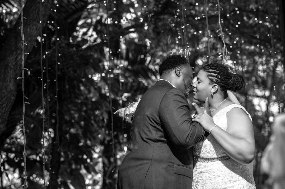 Bride holding bouquet by the lagoon at Secret Gardens, captured by Florida wedding photographers.