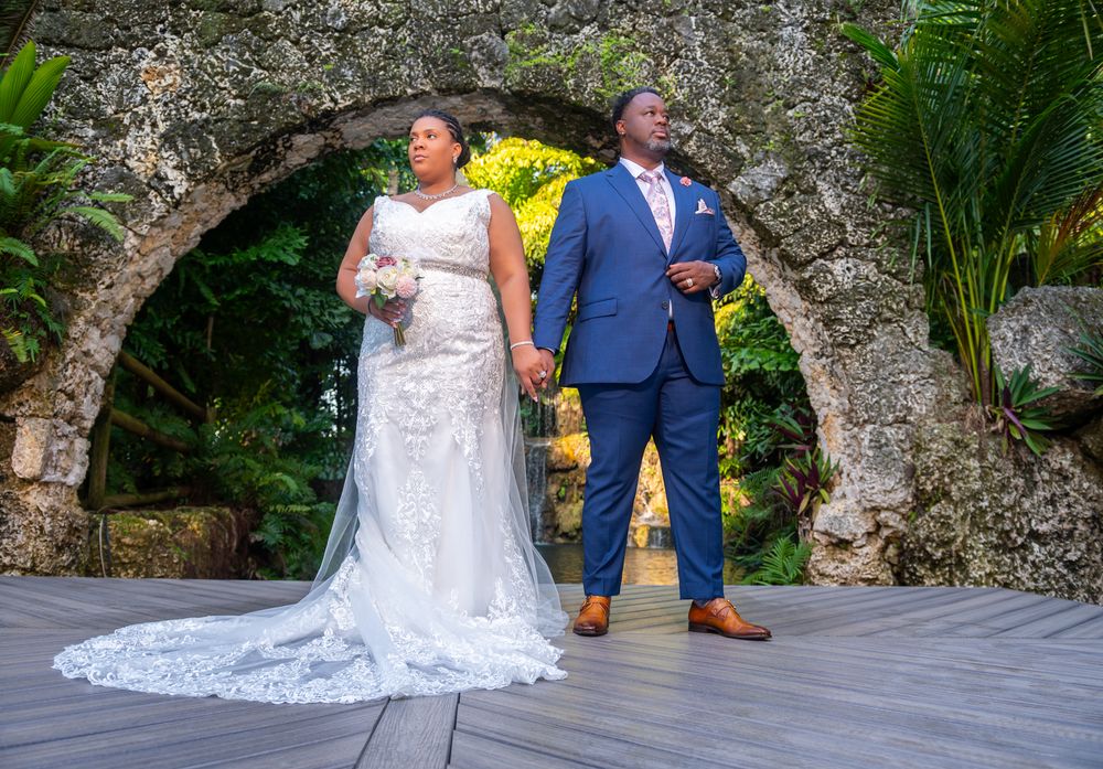 Golden hour portrait of bride and groom under banyan trees by South Florida wedding photographers.