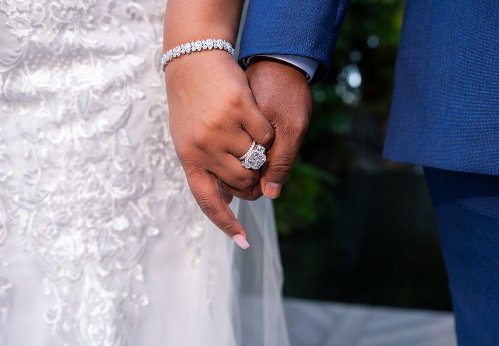 Romantic kiss by the water feature at Secret Gardens Miami, taken by Treasure Coast wedding photographers.