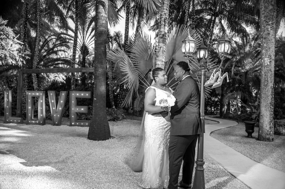 Jay straightens his tie near the koi pond, a timeless moment for Florida wedding photographers.