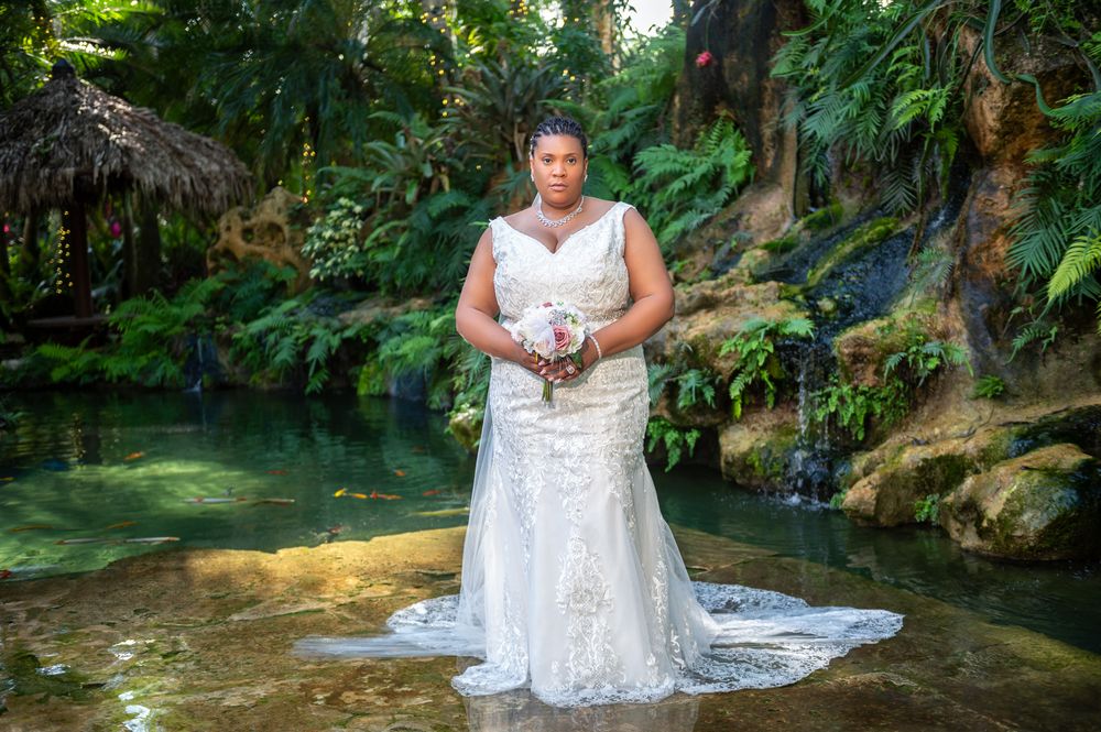 Grace and Jay say their vows in the garden oasis, captured by luxury wedding photographers in Florida.