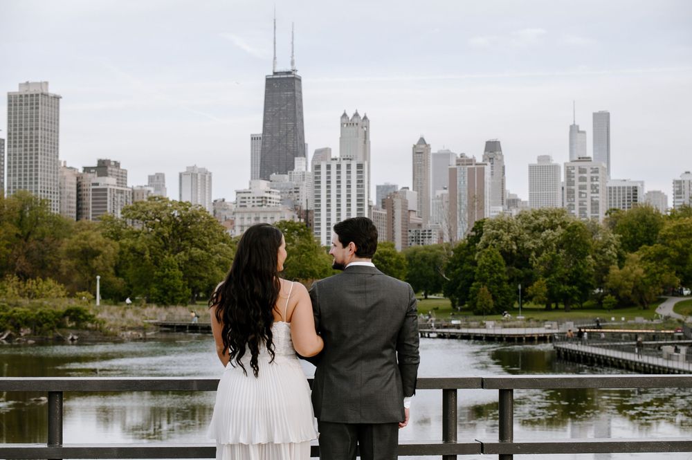 A couple admires Chicago's iconic skyline from a park bridge overlooking the North Pond at Lincoln Park.